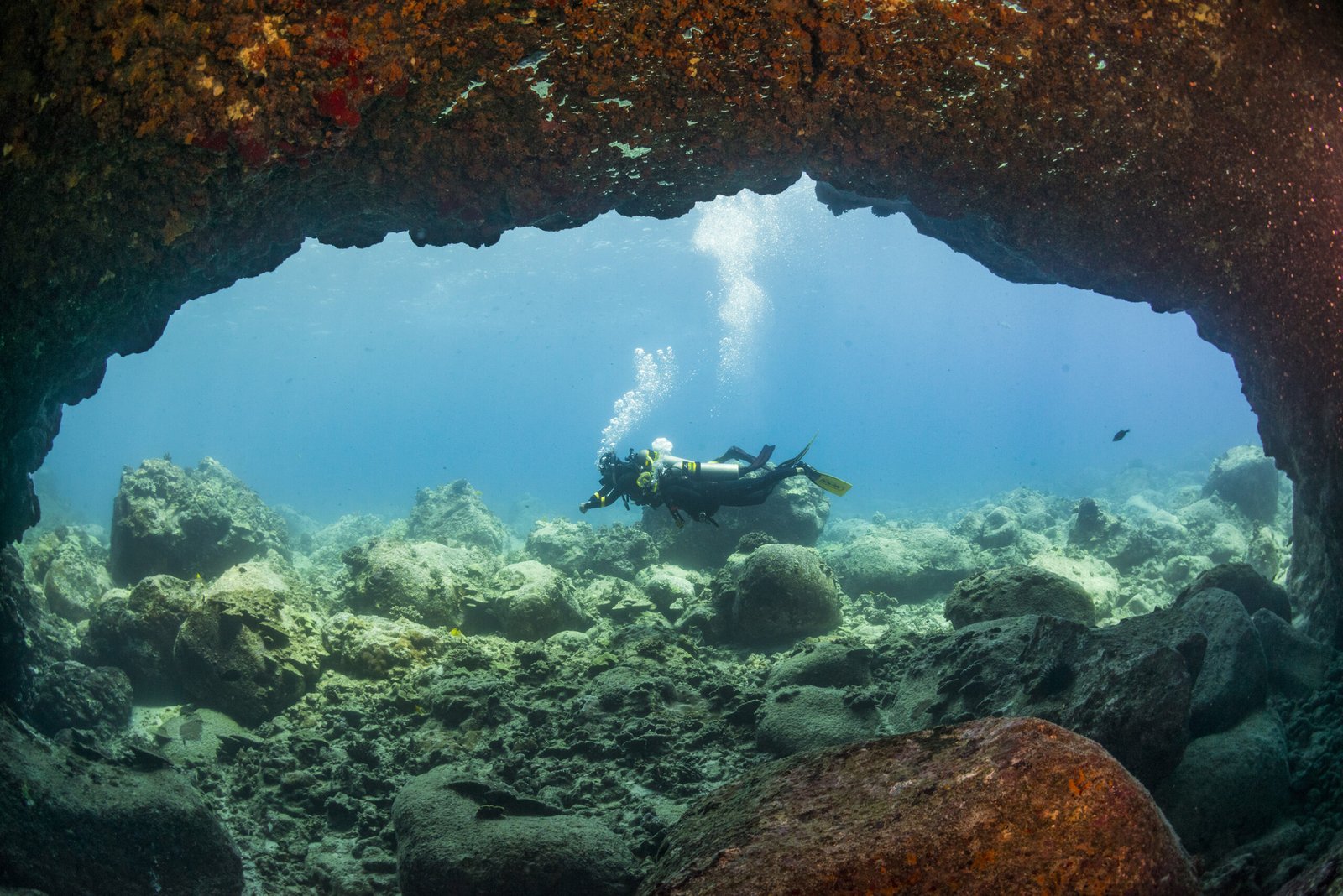DYVUM Enriched Air Nitrox diver exploring an underwater arch